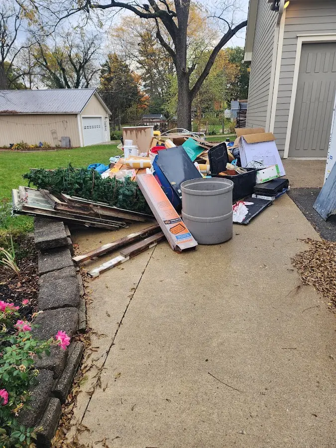 Dumpster being loaded with debris for Residential Dumpster Rental in Menomonee Falls